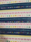 positive affirmation words coloured in pale rainbow colours using sun, moon, rainbows of pink on blue and white stripes