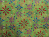 Australian Indigenous Aboriginal Dot Painting depicting flowers coloured red blue magenta white on a iridescent green background surrounded with tiny dots of green red  in the desert designed by Lauren Doolan
