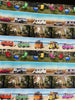 Scenic strips of camping chairs esky cars towing caravans campervans camping setup combi vans at the beach bright colours of red green yellow pink blue – 1089C