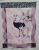 Fabric panel with Ostrich with rainbow coloured baseball cap, stockings and basketball shoes with a background of etched palm tree three rainbow coloured small birds on a mauve white stencilled leaf sides edged with spirals of pink and black top has blocks of flying geese in batik with leaves bottom corners have cerise leaves and bubbles