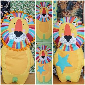 Cut and Sew Pillow on Green featuring a wide-eyed Lion on one side with sleeping Lion of reverse the rainbow of colours for his mane are bright and playful looking – DV3616
